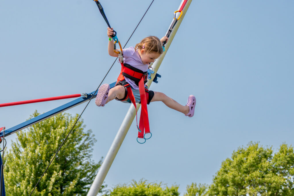 Home 1 Little girl enjoying a bungee trampoline rental from Jump City Inflatables in Minnesota